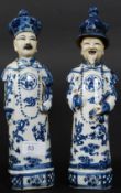 A  pair of 20th century Chinese blue and white figurines of scholars bearing character marks to the