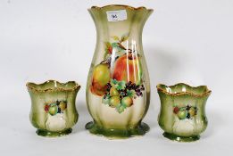 A three piece Staffordshire vase and gar