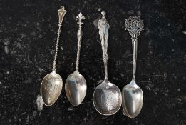 A collection of 4 decorative silver spoo