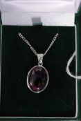 A silver and amethyst oval set pendant n