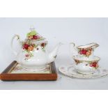 Royal Albert Country Roses tea pot, creamer, sugar bowl along with the Country Roses tea pot stand.