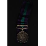 An Elizabeth II General Service Medal - Malaya Bar being issued to 4197814  S.A.C.