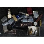 A mixed lot to include various lighters, razor, watches and other assorted similar items.