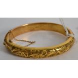 An early 20th century ladies rococo  gold plated bracelet with foliate engraving complete with the