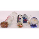 A collection of 8x assorted glass paperweights to include millefiori, horses head, seal and others.