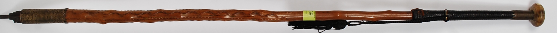 An unusual walking stick with cast metal tapered point being inscribed to the top,