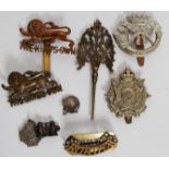 A collection of early 20th century military cap badges to include The Kings Own, Border Regt,