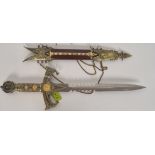 A contemporary dagger of decorative form complete with scabbard having double edge serrated blade