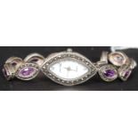 A contemporary silver 925 ladies dress watch with inset amethyst stone bracelet with lozenge shape