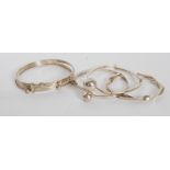 A collection of silver bangles to include puzzle bangle,  ball finial bangle and 2 others,