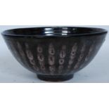 A Dennis Lucas studio pottery lustre glaze large fruit bowl having impressed double fish mark to