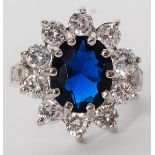 A ladies silver 925 ring set with a blue sapphire? stone having decorative surround. Weight 6.1g.