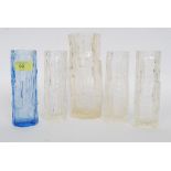 A collection of four clear glass bark va