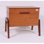 A retro 1970's Danish teak wood hinged sewing box raised on angled supports with hinged top and
