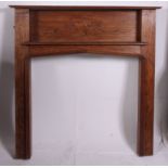 A good quality 1930's Art Deco style oak fireplace surround having embellished central panel with