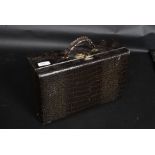 A vintage faux crocodile skin vanity case along with a similar faux lizard skin purse / handbag