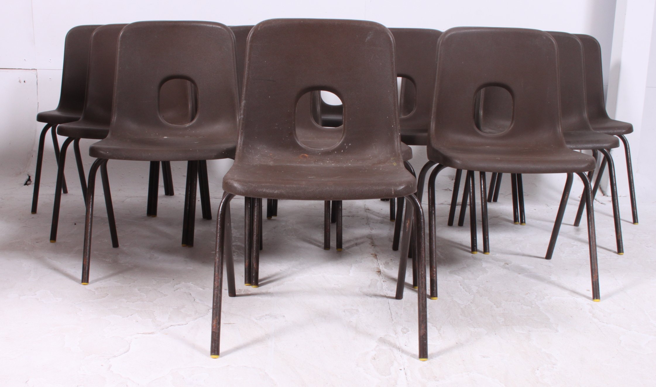 A stack of 13 vintage 1970's  Hille furniture plastic and tubular metal childrens school chairs.