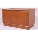 A retro 1970's teak wood window seat box having hinged lid raised on stub feet H45 W76 D41 cm