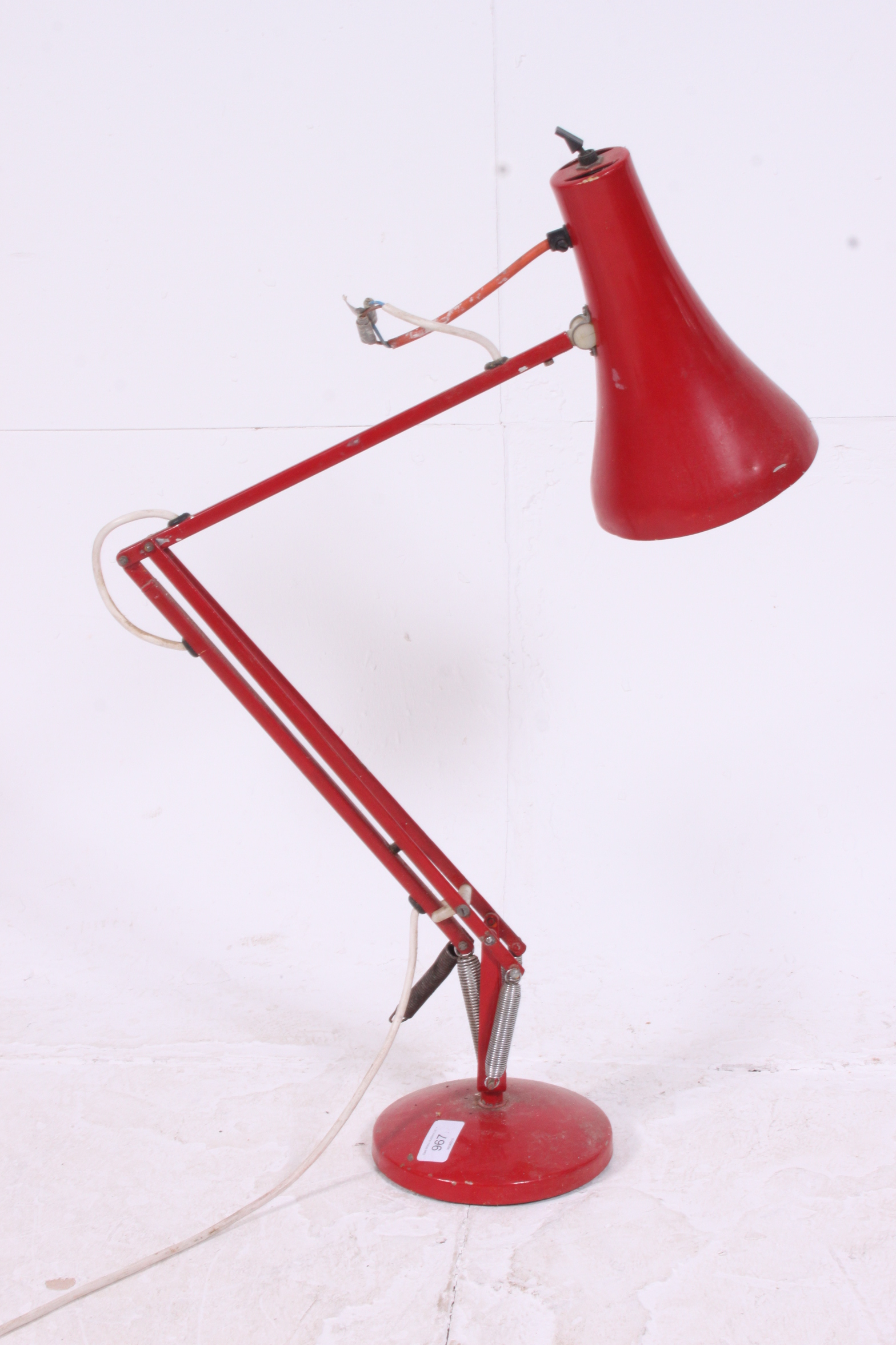 A vintage retro 20th century red Herbert Terry style anglepoise desk lamp with circular terraced