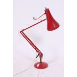 A vintage retro 20th century red Herbert Terry style anglepoise desk lamp with circular terraced