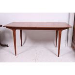 A 1970's teak wood retro Mcintosh dining table of rectangular form extending with flip over leaf,