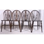 A set of 4 20th century Windsor wheelback dining chairs with turned legs having panel seats and