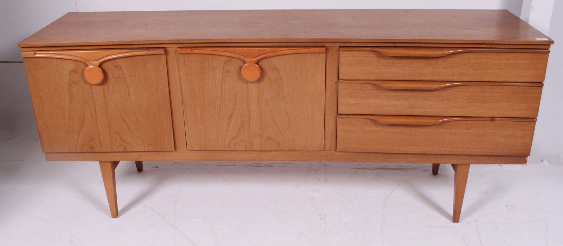 A retro 1970's Danish style teak wood low sideboard dresser raised on turned legs with a series of - Image 2 of 5