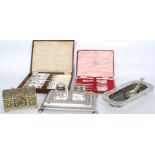 A collection of silver plated wares to include a desk tidy with glass inkwells, boxed flatware,