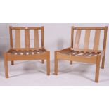 A pair of retro school / Industrial Ercol staff chairs ( lacking cushions ) bearing model no 747.