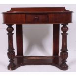 A Victorian mahogany Duchess style writing table desk of shaped form raised on turned legs with