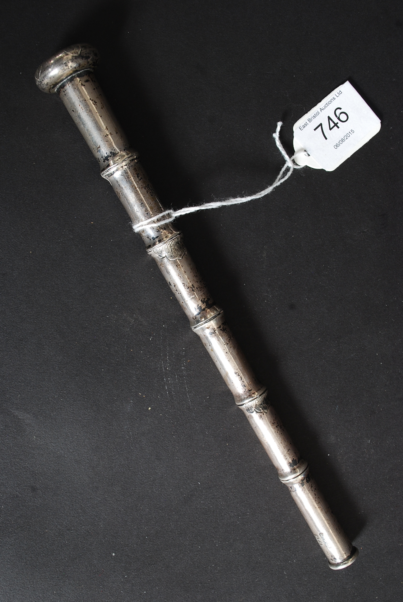 A silver Chinese hallmarked early 20th century ladies parasol handle bearing the initials for maker