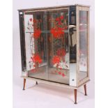 A 1950's retro formica and mirror glass display cabinet of colourful form with shelves to centre