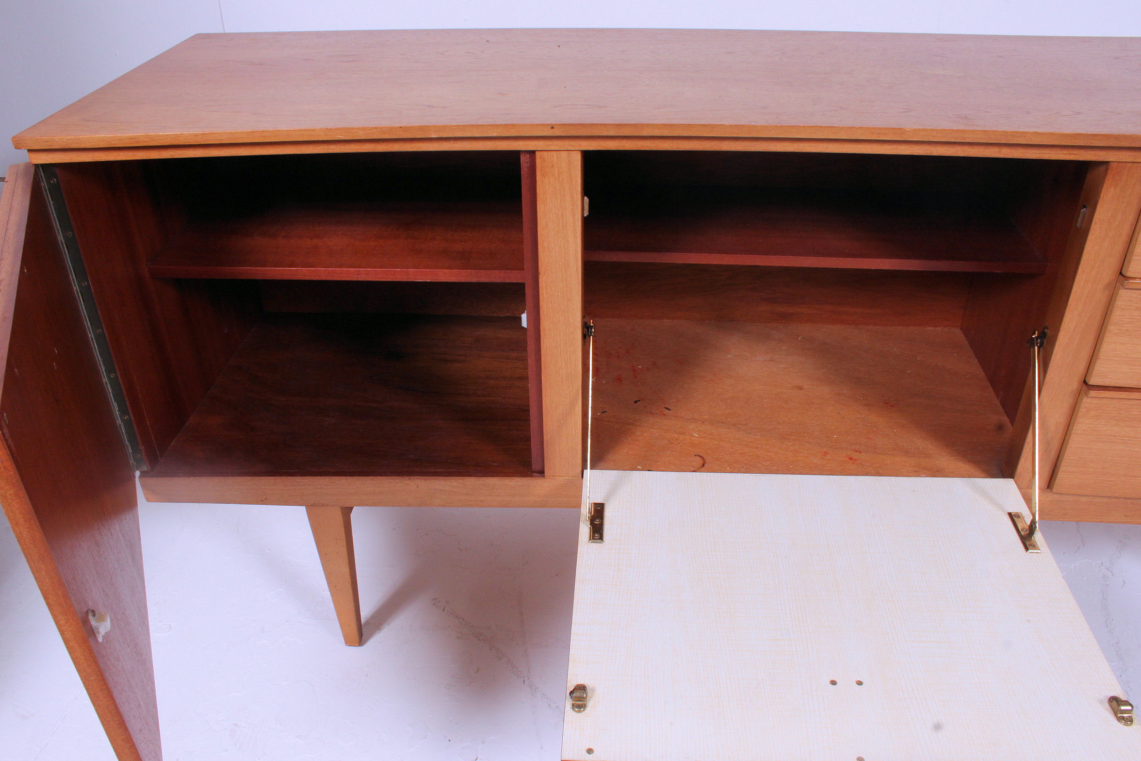 A retro 1970's Danish style teak wood low sideboard dresser raised on turned legs with a series of - Image 4 of 5