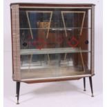 A vintage 1950's Formica retro display cabinet raised on tapering supports with decorative glass