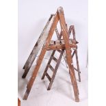 A collection of 20th century Industrial Three vintage wooden step ladders
