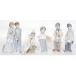 Nao / Lladro; A collection of 5x Nao / Lladro figurines - to include clowns,