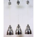 A set of three contemporary retro style chrome / polished steel finish rise and fall pendant light