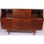 A 1970's retro G-Plan teak wood sideboard raised on tapered supports having a series of drawers and