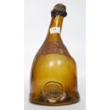 A vintage old champagne bottle with imperfections to the galas with an old label to centre having