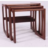 A 1970's G-Plan Kelso pattern retro teak wood nest of tables raised on shaped supports with