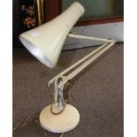 A vintage 20th century Herbert Terry anglepoise desk lamp in cream being marked to the arm for