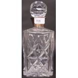 A cut glass decanter with stopper having a silver hallmarked silver collar