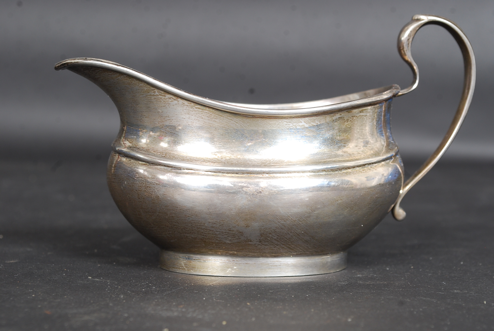 A hallmarked silver creamer jug with marks for Birmingham and a date letter O.