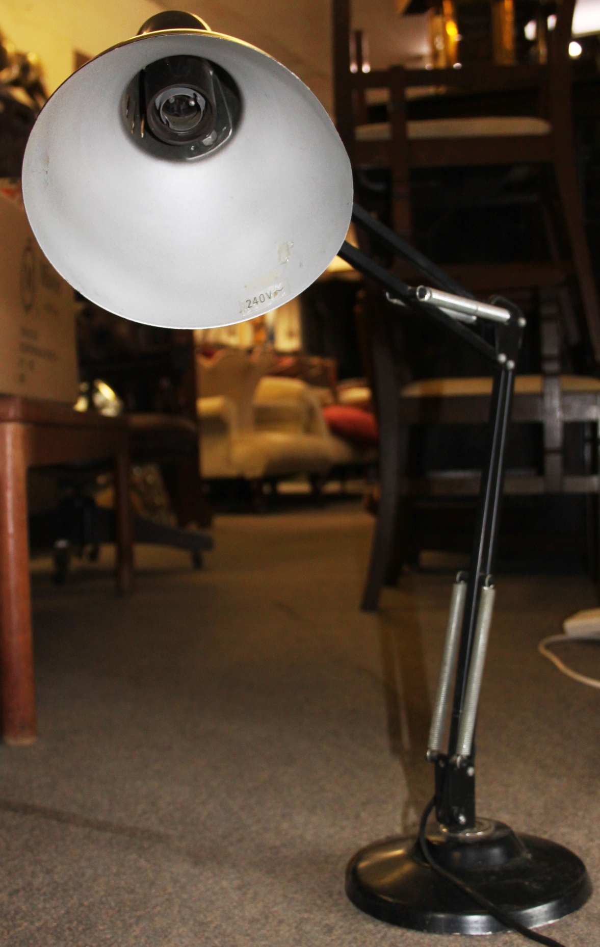 A vintage 20th century black anglepoise industrial desk lamp having heavy circular base with