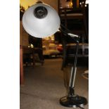 A vintage 20th century black anglepoise industrial desk lamp having heavy circular base with
