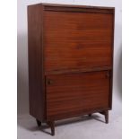 A vintage / retro drinks cabinet having a fully appointed interior accessed by a drop down front