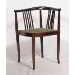 An Edwardian mahogany inlaid corner chair having green velour padded seat raised on tapered legs