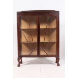 A 1940's sunburst effect oak display cabinet having astragal sunrise style glass door with lined