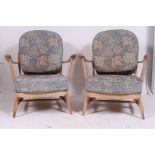 A pair of 1970's retro Ercol beech and elm Windsor pattern armchairs.