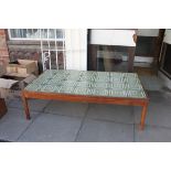 A large 1970's Danish teak and tile top oversized coffee table by Trioh.